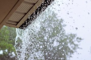 rain downpour off of home's gutters