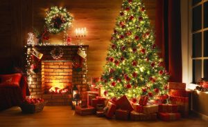 christmas tree w/ lights near fireplace
